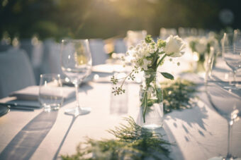 Beautiful Outdoor Table Setting With White Flowers For A Dinner,